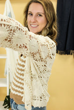 Load image into Gallery viewer, Model is wearing a cream crochet cardigan
