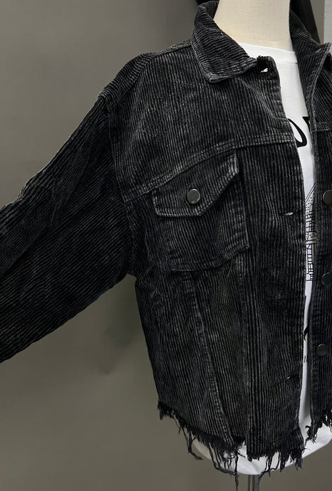 Mannequin is wearing a black distressed corduroy shacket. 