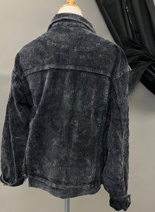 Mannequin is wearing a black distressed corduroy shacket. 