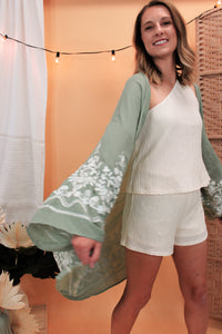 model is wearing a sage color kimono.
