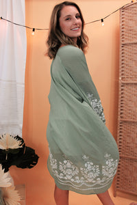 model is wearing a sage color kimono.