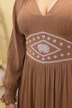 Load image into Gallery viewer, Model is wearing the Logan dress with western inspired accessories and a western inspired backdrop. 

