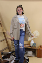 Load image into Gallery viewer, Model is wearing the dark wash distressed jasmine jeans in front of a western inspired backdrop. 
