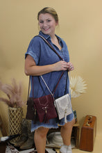 Load image into Gallery viewer, Image shows a faux leather crossbody bag with tassle in a western style, available in four colors, brown, burgundy, black and cream.

