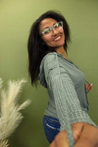 Model is wearing a green waffle knit hoodie.