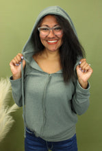 Load image into Gallery viewer, Model is wearing a green waffle knit hoodie.
