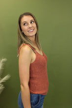 Load image into Gallery viewer, Model is wearing a brick colored sweater tank in front of a fall theme background. 
