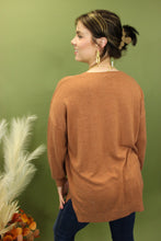 Load image into Gallery viewer, Model is wearing an oversized rust colored sweater. 
