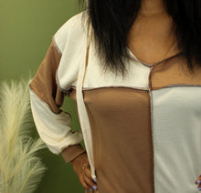 Load image into Gallery viewer, Model is wearing a cream and taupe color block sweatshirt. 
