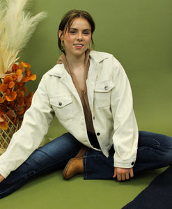 Model is wearing a cream color corduroy jacket. 