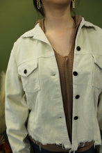 Load image into Gallery viewer, Model is wearing a cream color corduroy jacket. 
