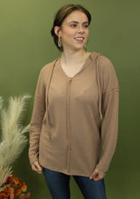 Load image into Gallery viewer, Model is wearing a camel waffle knit hoodie.
