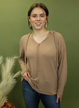 Load image into Gallery viewer, Model is wearing a camel waffle knit hoodie.
