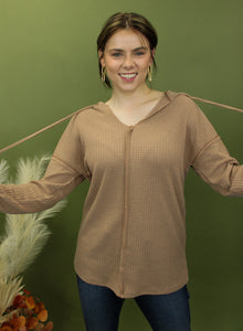 Model is wearing a camel waffle knit hoodie.