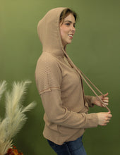 Load image into Gallery viewer, Model is wearing a camel waffle knit hoodie.
