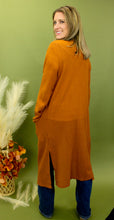Load image into Gallery viewer, Model is wearing a longline rusty orange waffle knit cardigan. 
