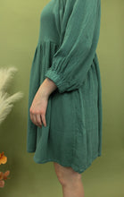 Load image into Gallery viewer, Model is wearing a  3/4 sleeve hunter green mini dress. 
