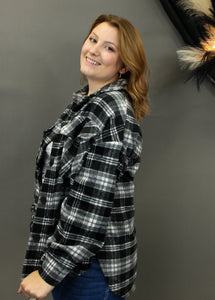 Model is wearing a black and white plaid shacket.