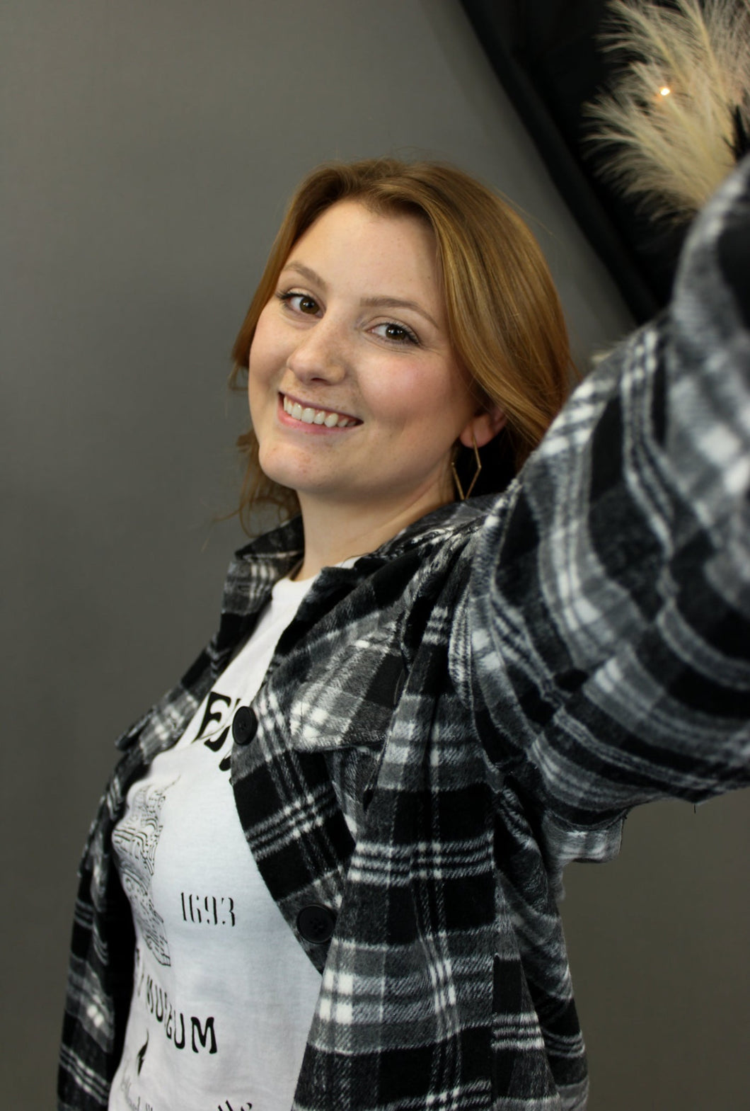 Model is wearing a black and white plaid shacket.