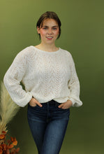Load image into Gallery viewer, Model is wearing a white open knit sweater. 
