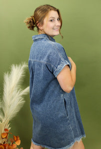 Model is wearing a dark wash denim dress.