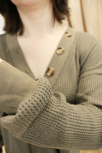 Load image into Gallery viewer, Model is wearing a mocha colored waffle knit top. 

