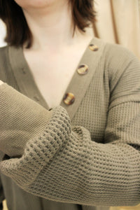 Model is wearing a mocha colored waffle knit top. 