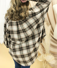 Load image into Gallery viewer, Model is wearing a brown and cream flannel button up shirt. 
