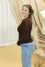 Load image into Gallery viewer, Model is wearing a brown rib knit sweater. 
