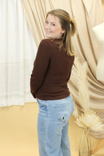 Load image into Gallery viewer, Model is wearing a brown rib knit sweater. 
