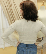 Load image into Gallery viewer, Model is wearing a slightly cropped neutral color sweater with a hint of sparkles. 
