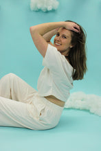 Load image into Gallery viewer, Model is wearing a white crop top and matching pant. 
