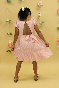 Model is wearing a peach floral dress. 