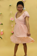 Load image into Gallery viewer, Model is wearing a peach floral dress. 
