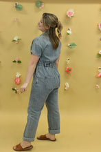 Load image into Gallery viewer, Model is wearing a short sleeve denim jumpsuit. 

