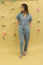 Load image into Gallery viewer, Model is wearing a short sleeve denim jumpsuit. 
