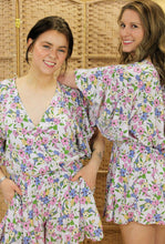 Load image into Gallery viewer, Models are wearing a floral romper. 
