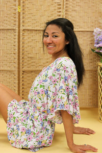Models are wearing a floral romper. 
