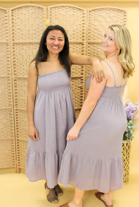 Models are wearing a lilac color midi dress.