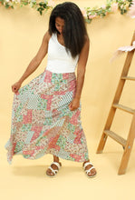 Load image into Gallery viewer, Model is wearing a patchwork print skirt.
