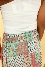 Load image into Gallery viewer, Model is wearing a patchwork print skirt.
