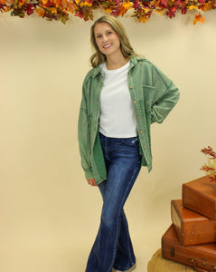 Model is wearing a green shacket. 