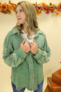 Model is wearing a green shacket. 