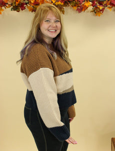 Model is wearing a color block sweater. 