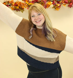 Model is wearing a color block sweater. 