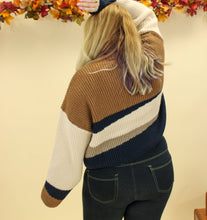 Load image into Gallery viewer, Model is wearing a color block sweater. 
