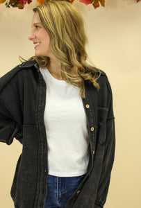 Model is wearing a black shacket. 