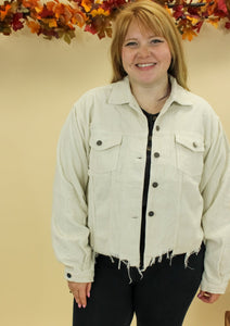 Model is wearing a cream color corduroy jacket. 