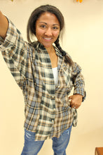 Load image into Gallery viewer, Model is wearing a plaid oversized button up shirt. 
