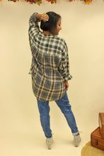 Load image into Gallery viewer, Model is wearing a plaid oversized button up shirt. 
